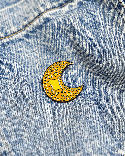 Decorative gamar boba inspired pin on a denim background inspired by sudanese culture on a brown bag as part of islamic relief uk new sudan souq collection