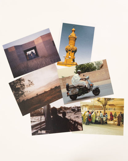 Collection of photographs printed as postcards on a brown background inspired by sudanese culture on a brown bag as part of islamic relief uk new sudan souq collection