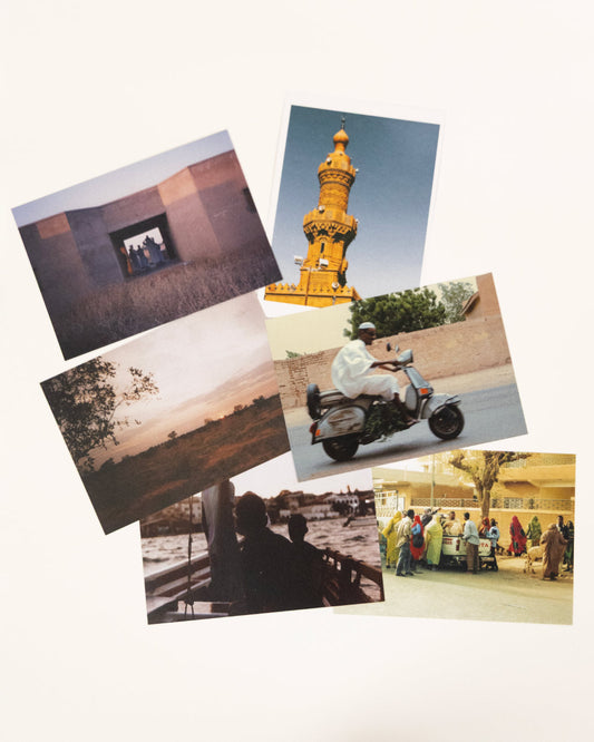 Collection of photographs printed as postcards on a brown background inspired by sudanese culture on a brown bag as part of islamic relief uk new sudan souq collection