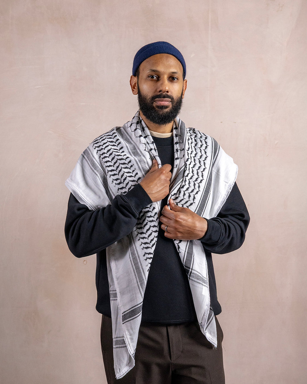 a man wearing the palestinian black and white keffiyeh