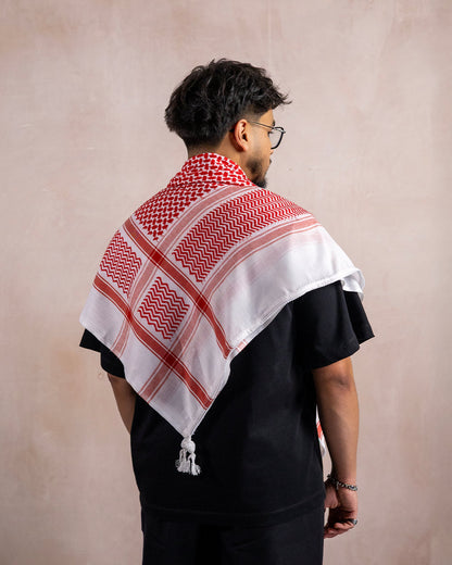 a man wearing the palestinian red and white keffiyeh