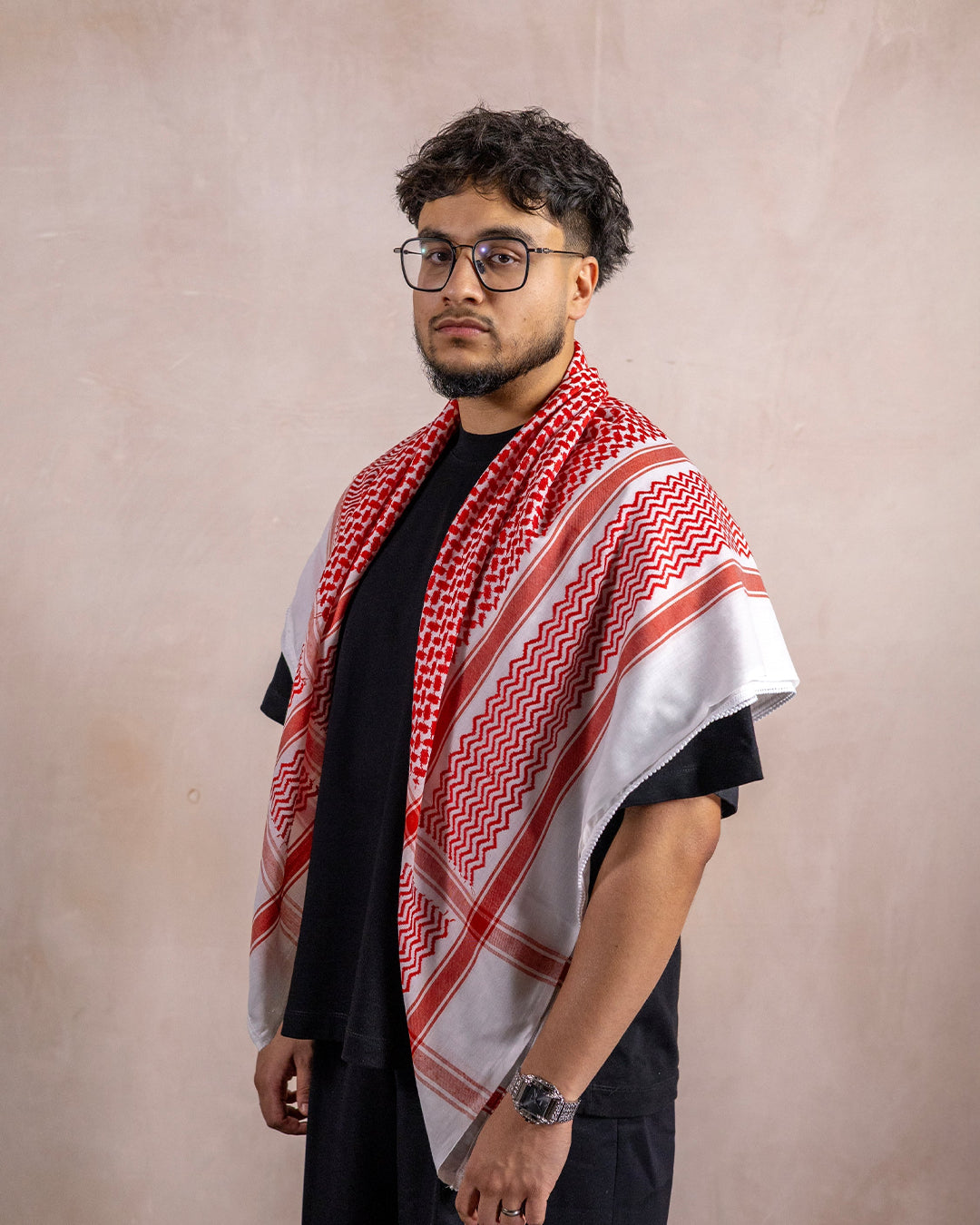 a man wearing the palestinian red and white keffiyeh