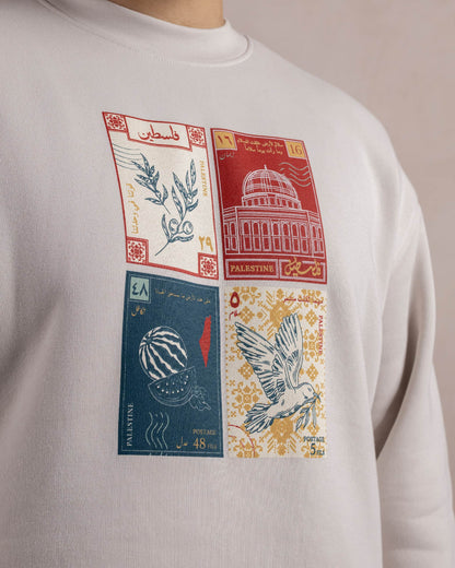 A closeup of a light beige sweatshirt printed with a design inspired by palestinian culture
